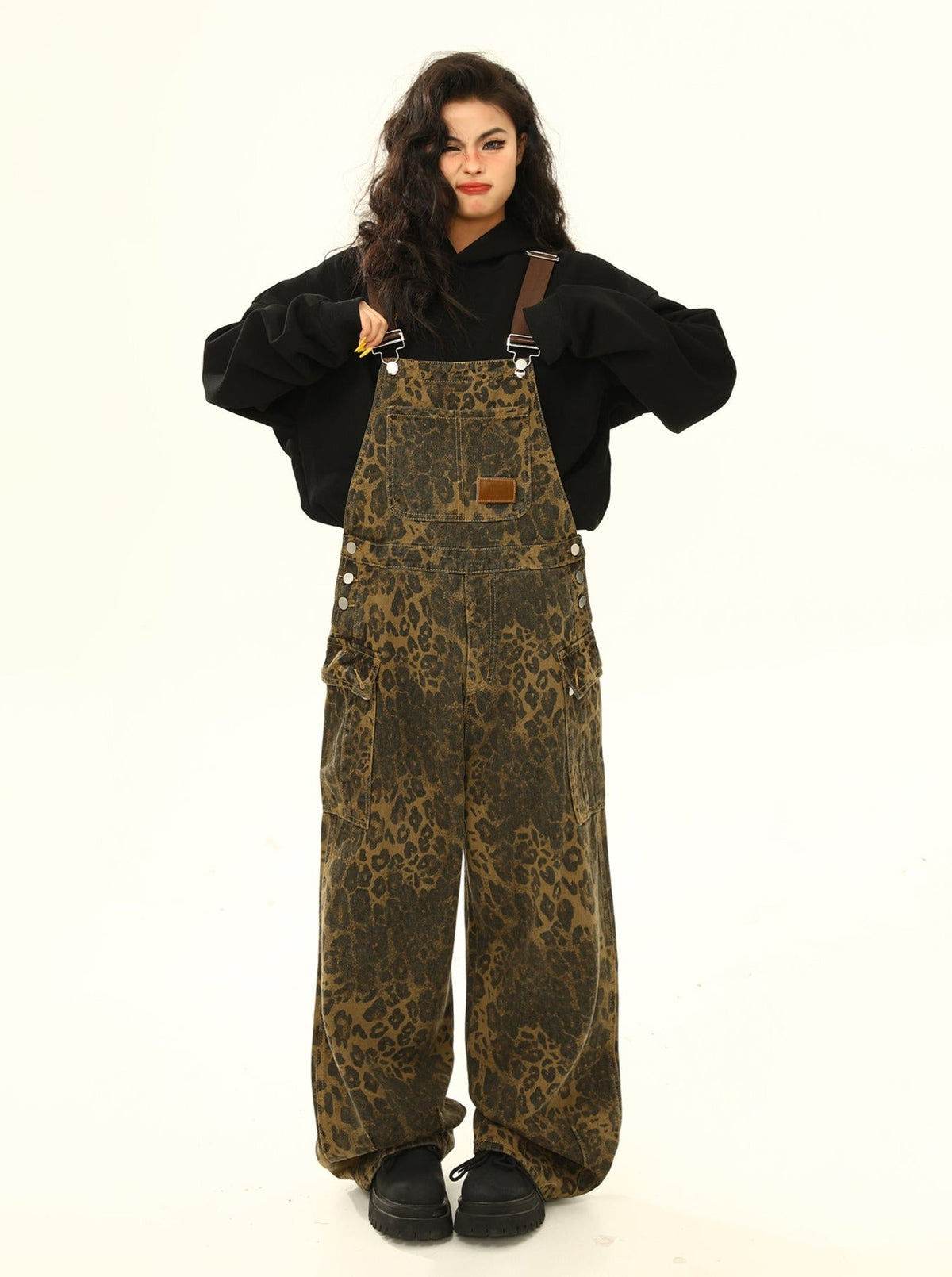 Wild Azi brown leopard-print denim overalls styled with a black hoodie and chunky black shoes