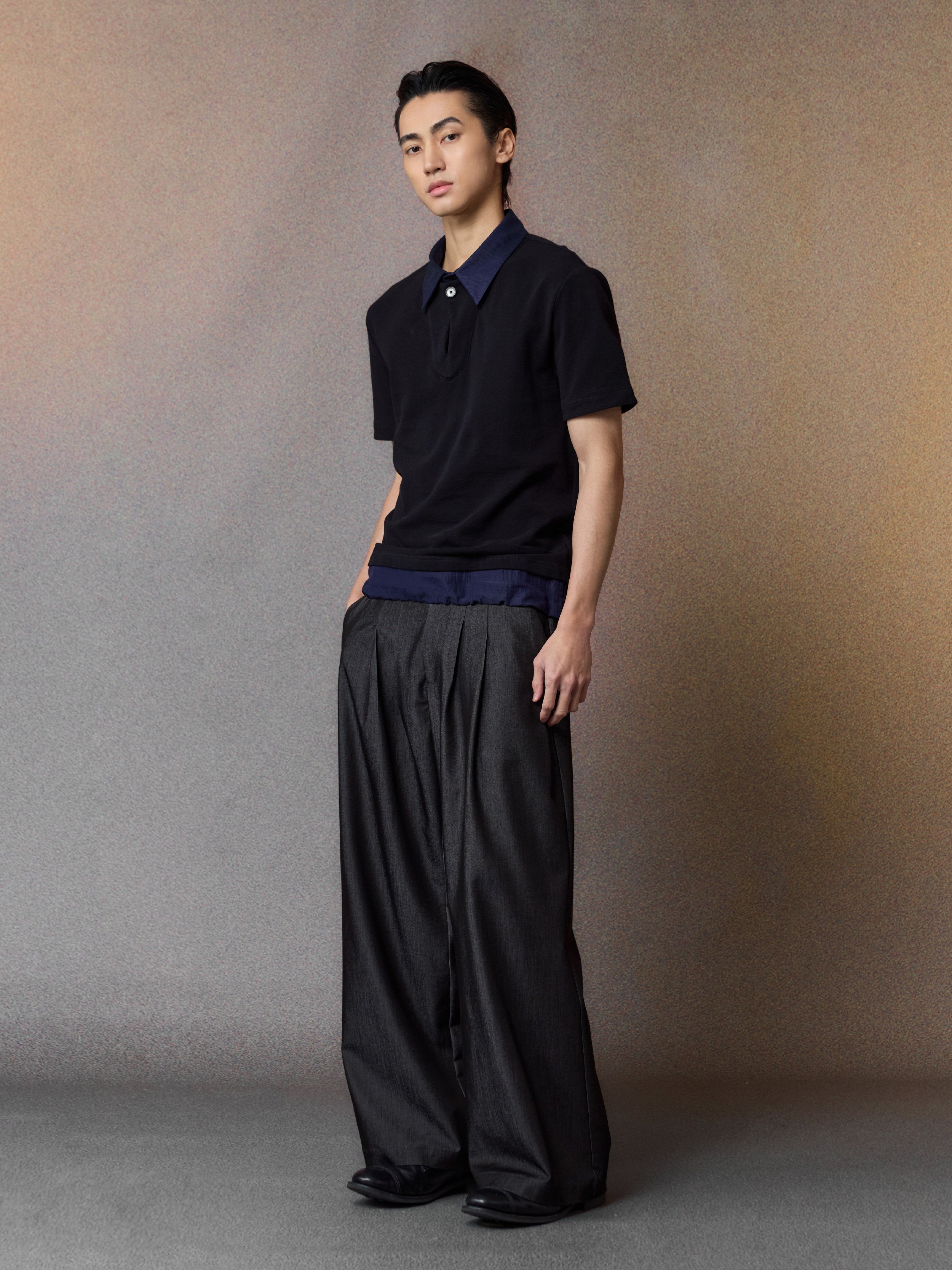 Black pleated wide-leg trousers, full model view