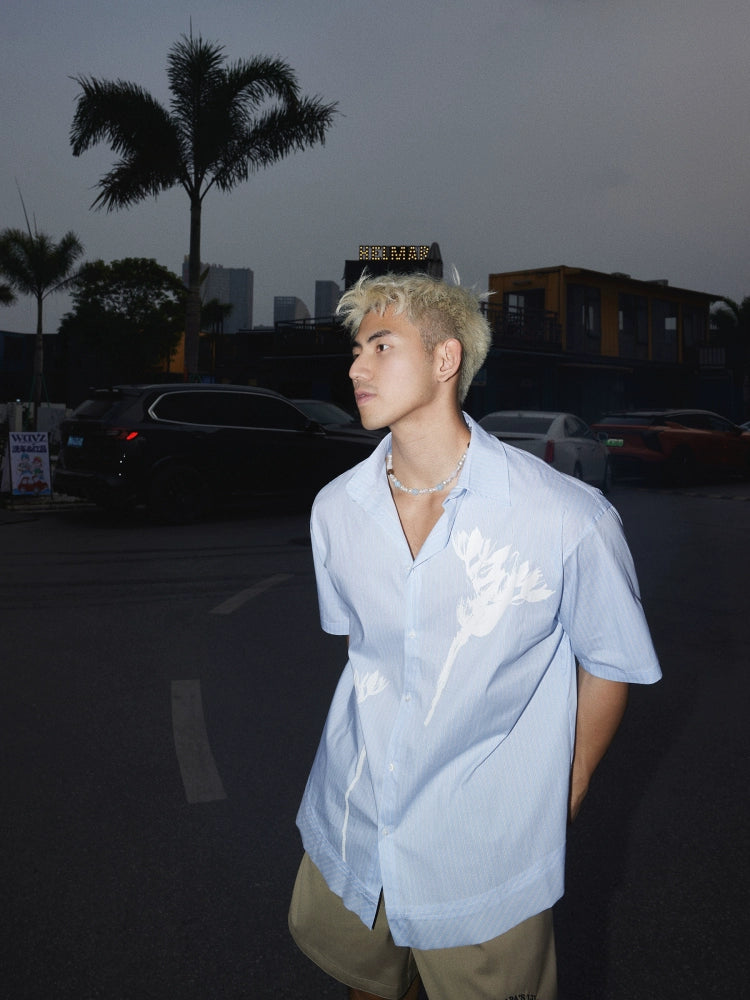 Light Blue Short-Sleeve Button-Up Shirt with White Floral Print