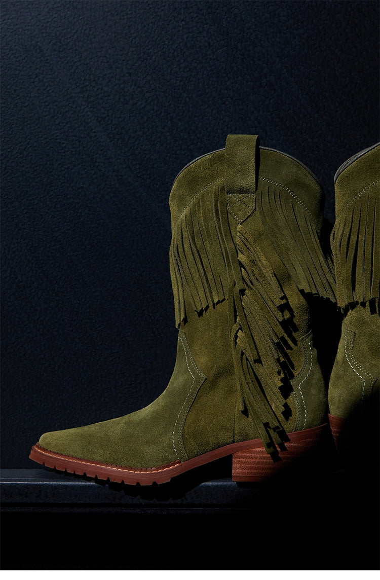 Cowboy boot with fringe detailing and a brown stacked heel