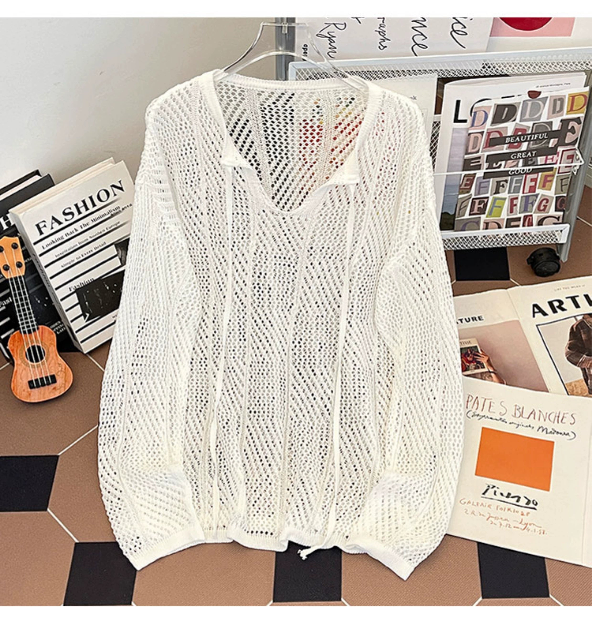 Oversized mesh knit sweater with a drawstring neckline