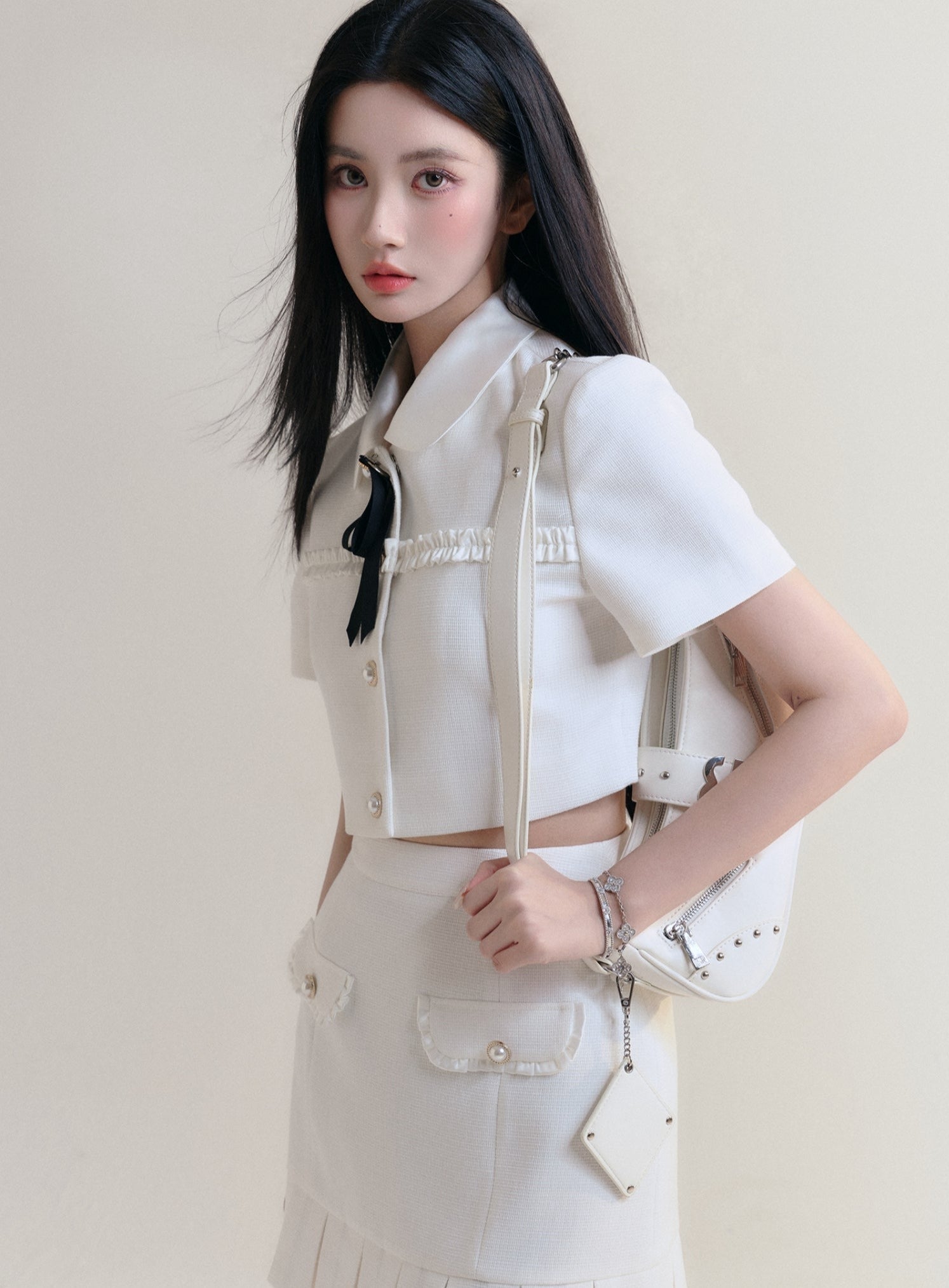 Ivory Elegance Bow-Tie Crop Blouse and Pleated Mini Skirt Set