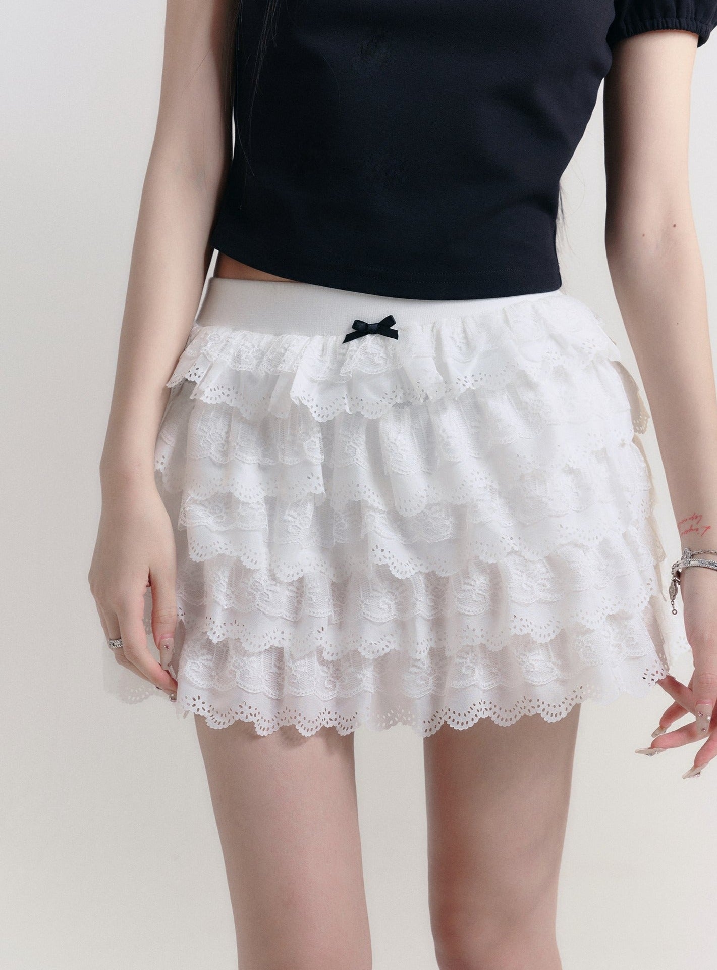 Angelic Tiers Mini Skirt: White Lace Ruffle Layers with Bow Accent