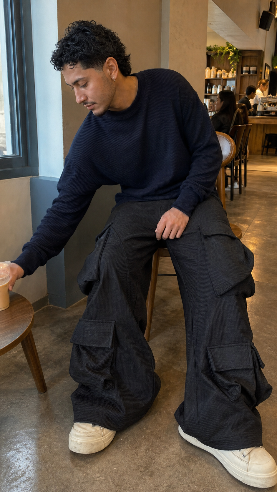 Men's Multi-Pocket Curved Wide-Leg Cargo Pants seated cafe showcase