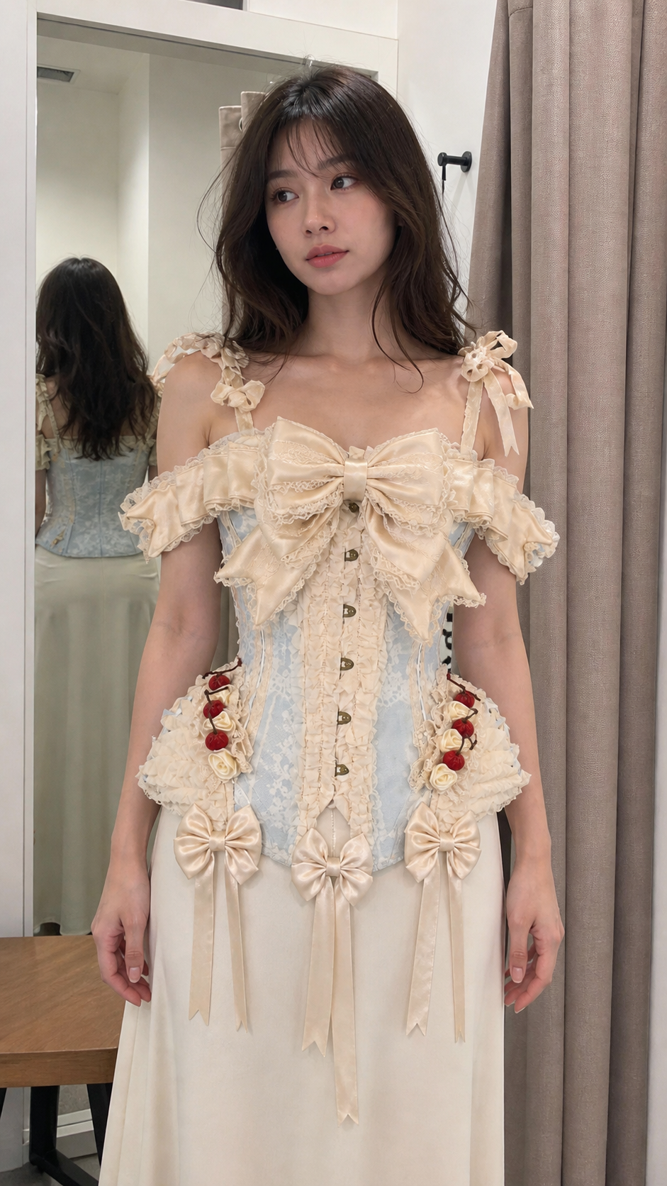 Natural fitting-room photo featuring the cream and powder-blue off-shoulder ribbon corset top