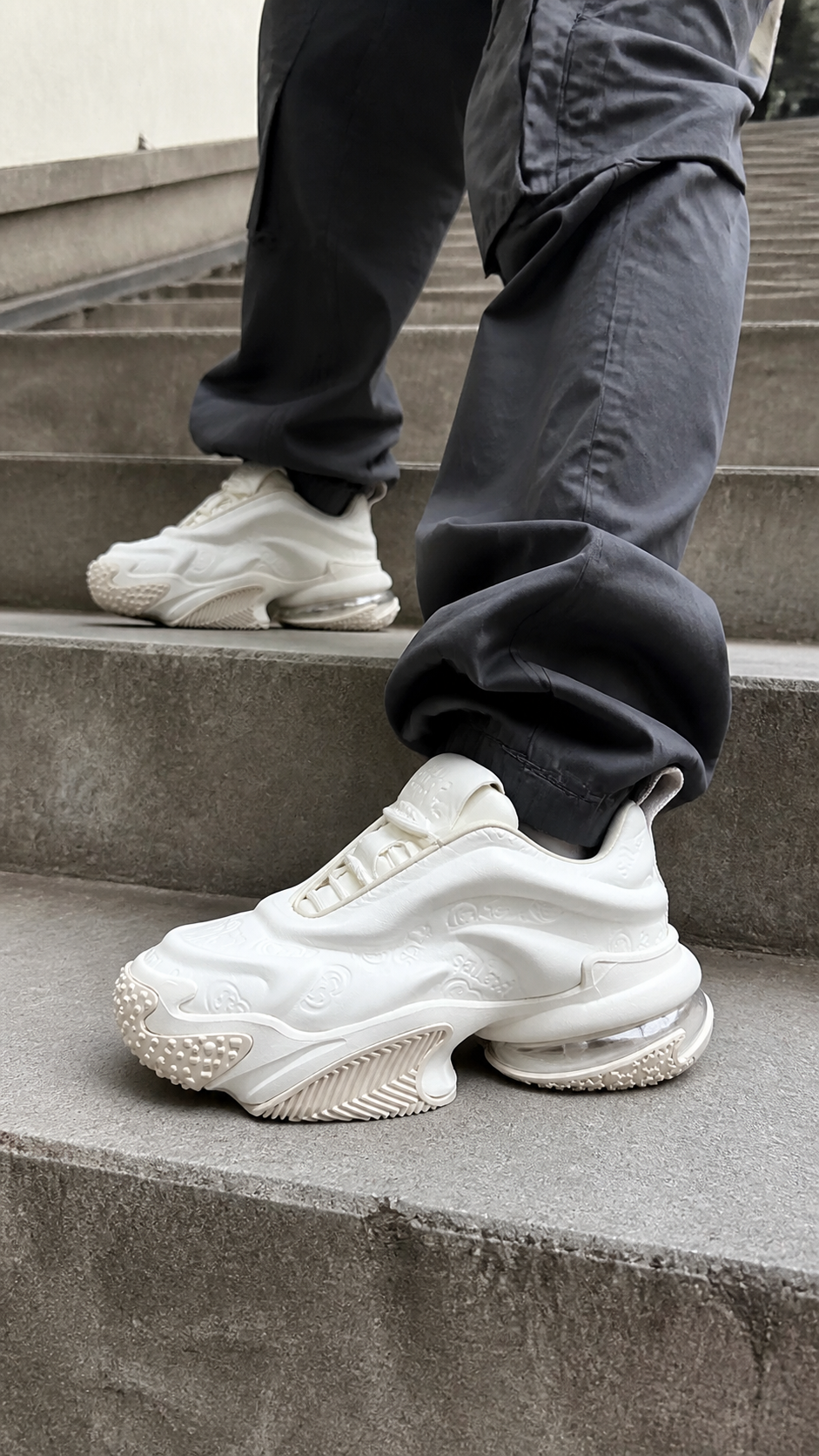 White Vortex Embossed Platform Sneakers styled on city steps