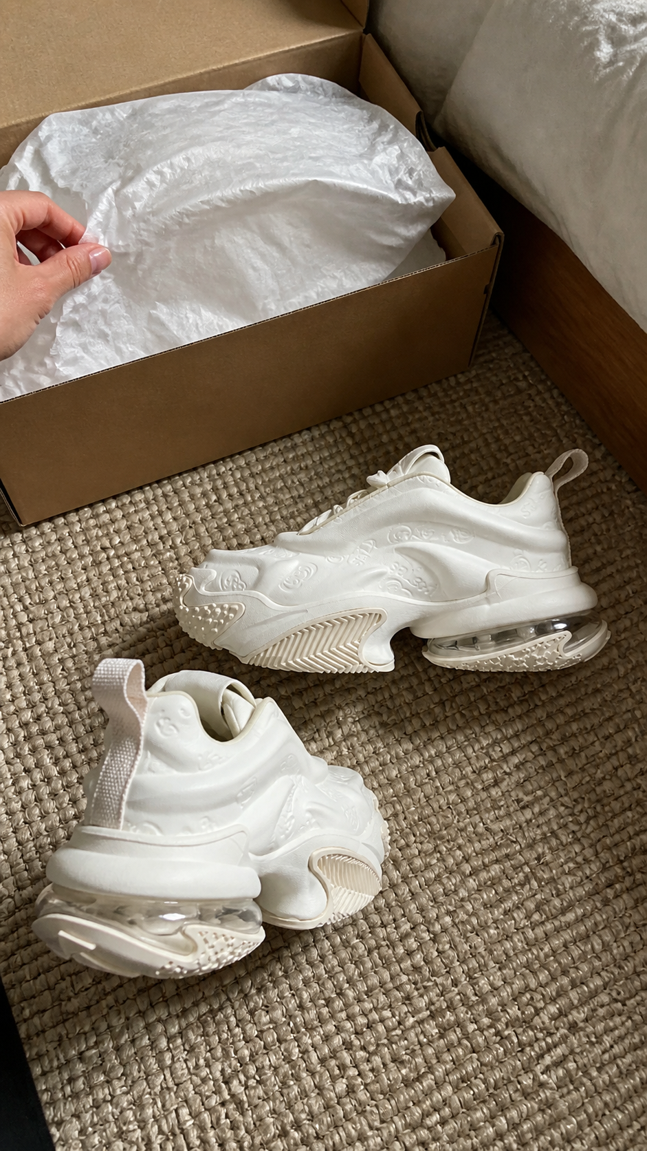 White Vortex Embossed Platform Sneakers in a natural bedroom unboxing