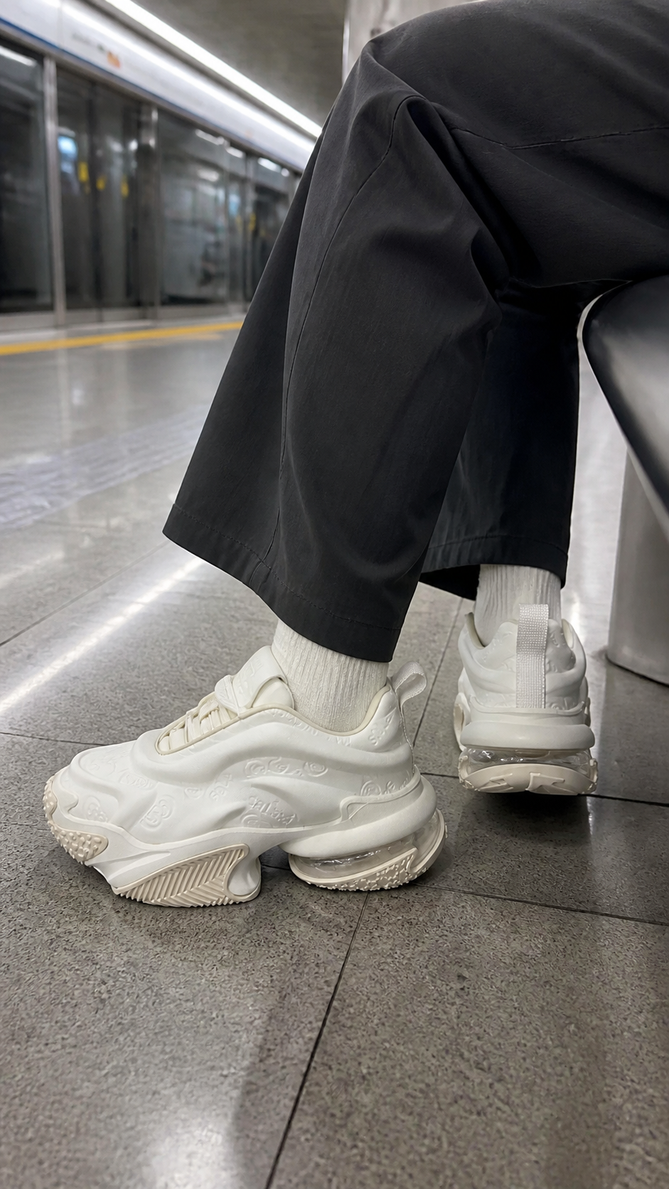 White Vortex Embossed Platform Sneakers in a casual transit bench outfit