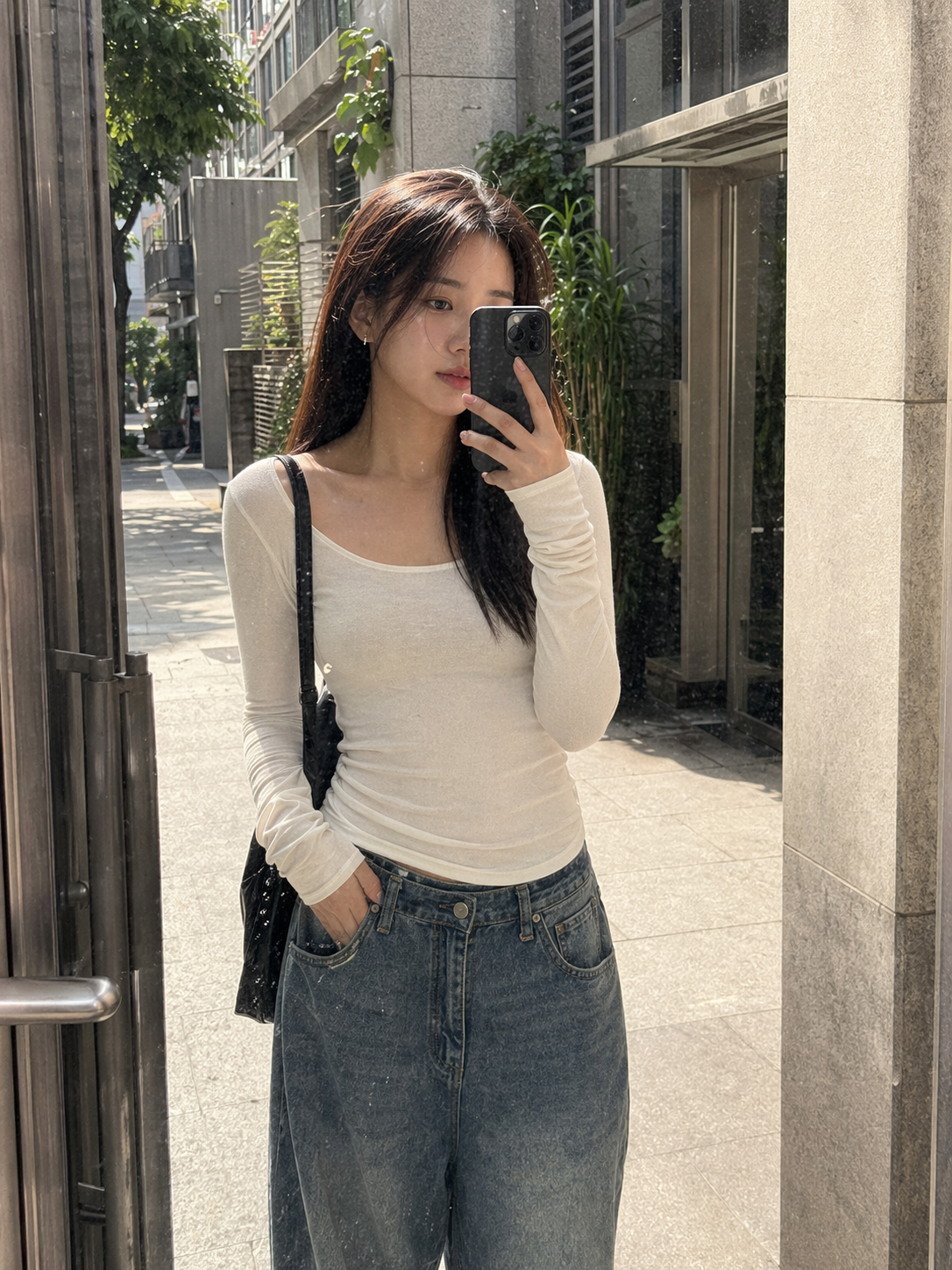 UGC showcase 5 for Long Sleeve Basic Tee: Asian woman taking an outdoor reflection selfie in Taipei.