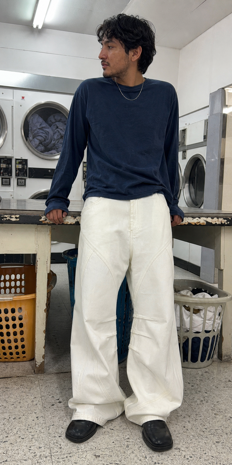 UGC laundromat styling of Men's Frayed Wide-Leg Machete Jeans