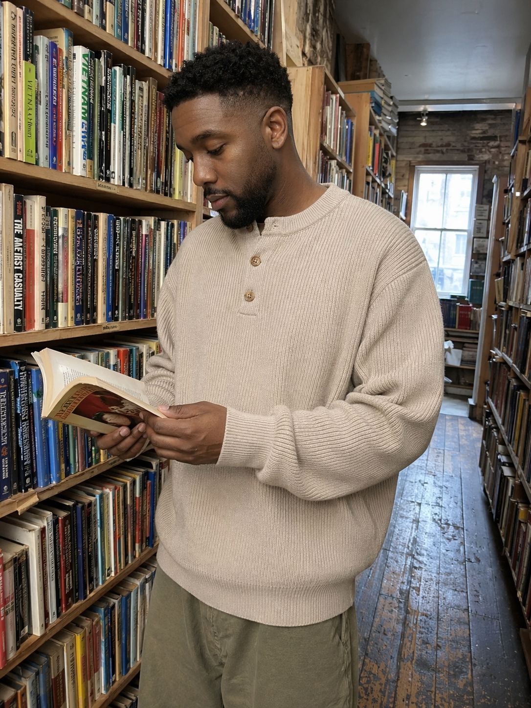 UGC showcase 5 for Waffle Henley Knit Sweater: Black American man in a Chicago bookstore.